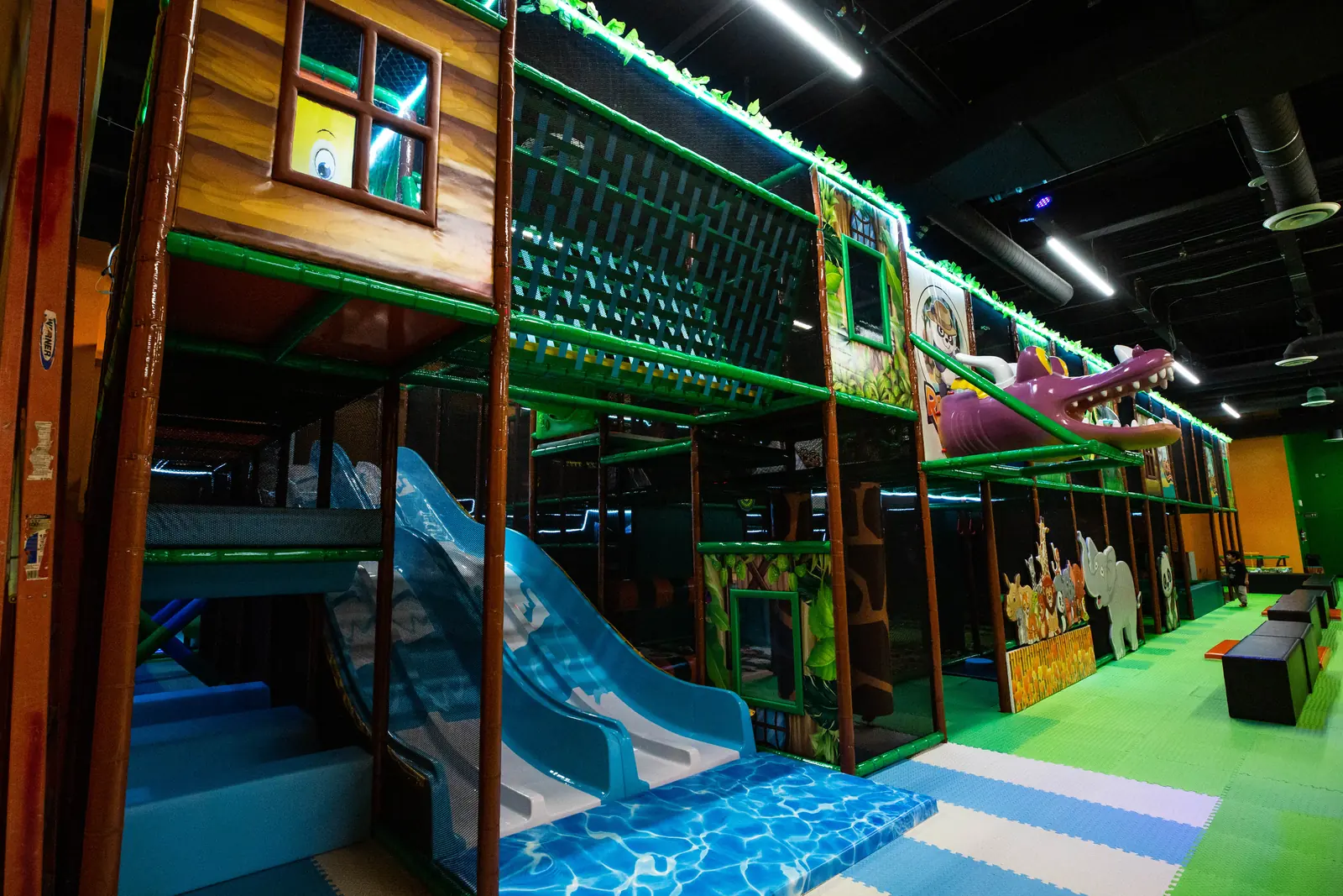 The blue indoor slide seen from the play floor