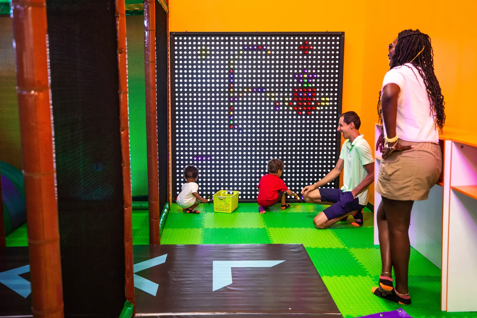 A child climbing the padded climbing wall