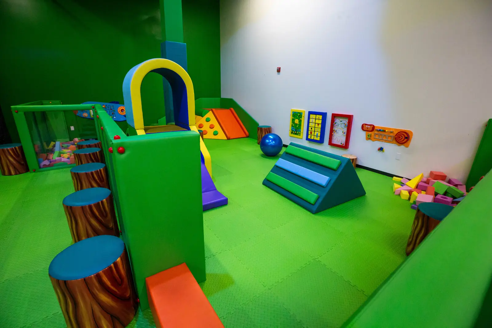 Wide view of the Soft Play Area with padded climbing pieces, wall activities and foam blocks