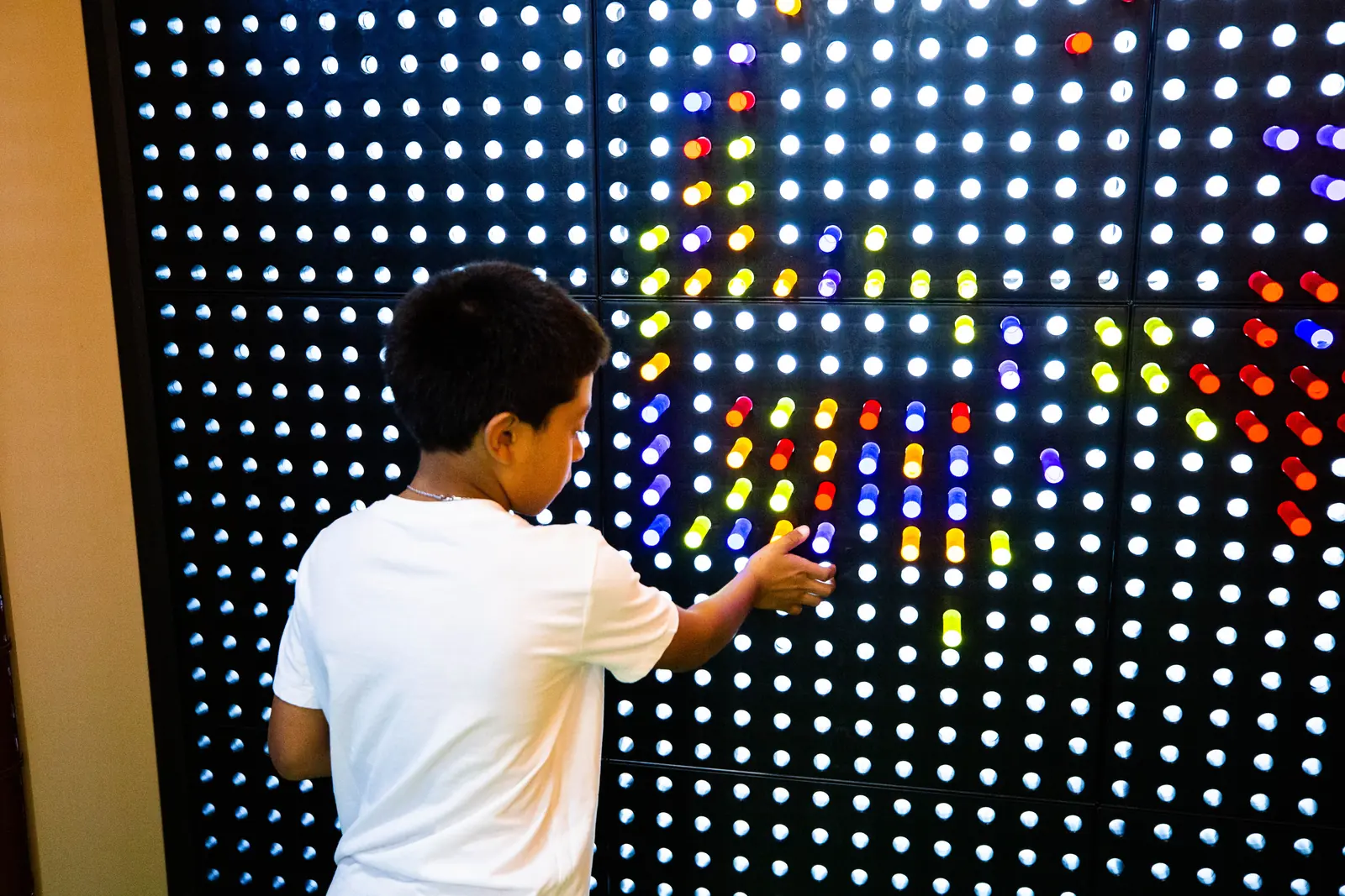 A child playing at the interactive light wall