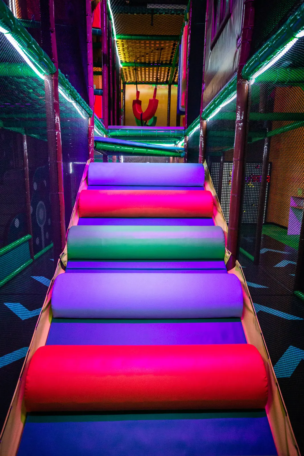 Colorful rainbow steps leading up into the play structure